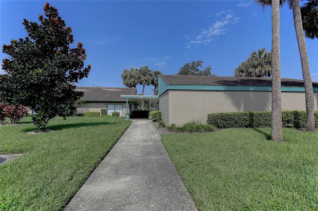 8405 Terrace Meadows Court, Unit 8405 Temple Terrace, FL 33637 - Photo 25 of 28 a front view of a house with a yard and garage