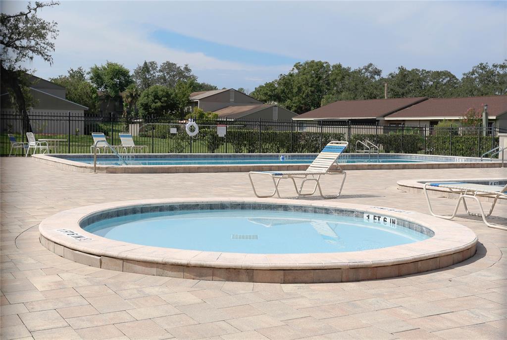 8405 Terrace Meadows Court, Unit 8405 Temple Terrace, FL 33637 - Photo 26 of 28 a view of swimming pool with outdoor seating and yard in back