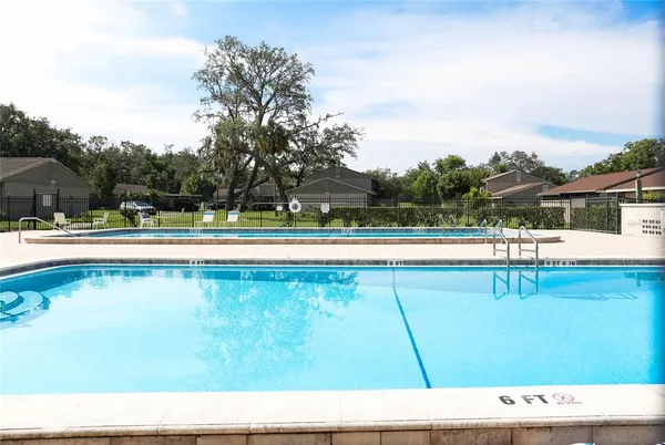 a view of a swimming pool with a yard