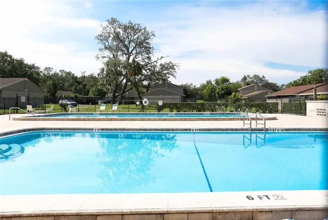 a view of a swimming pool with a yard