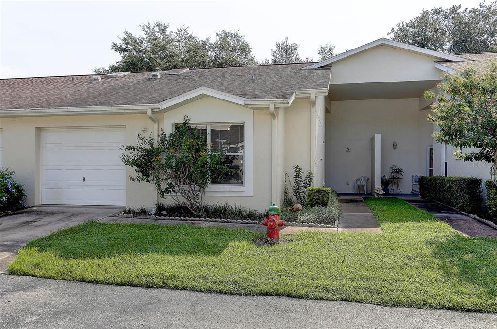 8405 Terrace Meadows Court, Unit 8405 Temple Terrace, FL 33637 - Photo 3 of 28 a front view of a house with a yard and garage