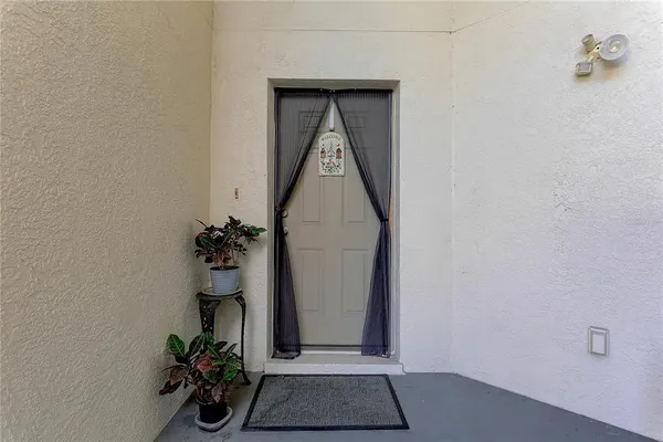 a view of a hallway with a flower pot
