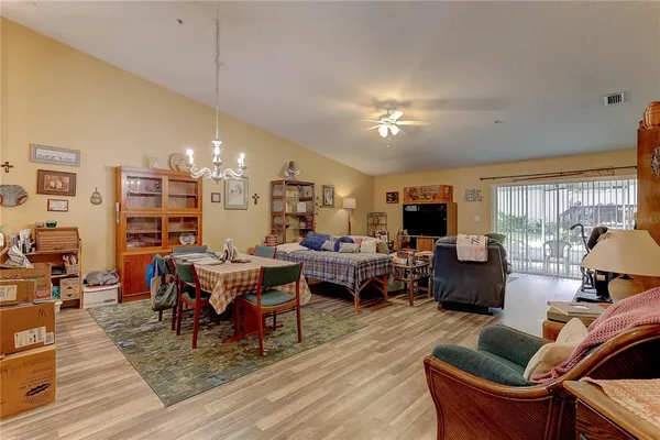 a living room with lots of furniture and view of kitchen