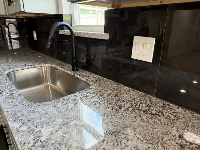 a kitchen with a sink and a refrigerator