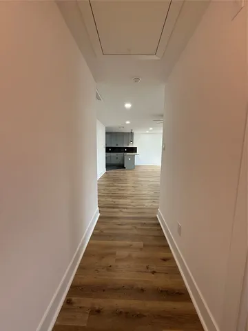 a view of a hallway with wooden floor