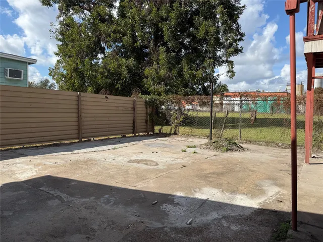 a view of a backyard with a tree