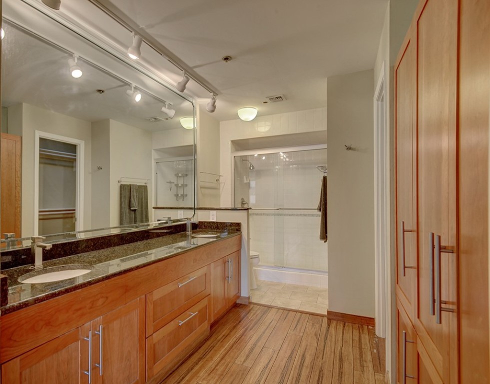 40 North Interstate Highway 35, Unit 2C2 Austin, TX 78701 - Photo 15 of 35 a bathroom with a granite countertop sink mirror and shower