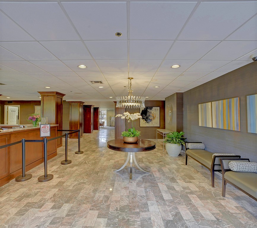 40 North Interstate Highway 35, Unit 2C2 Austin, TX 78701 - Photo 33 of 35 a living room filled with furniture and a chandelier