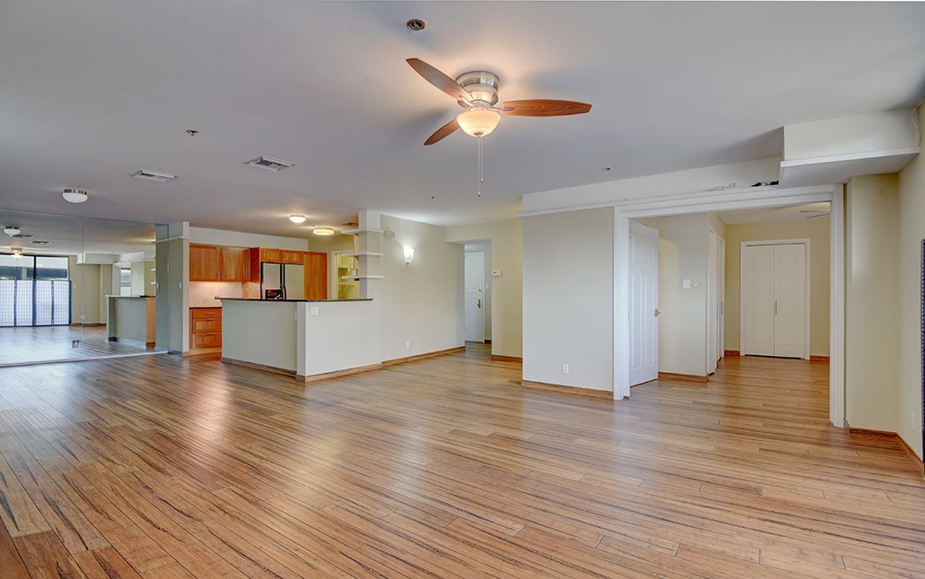 40 North Interstate Highway 35, Unit 2C2 Austin, TX 78701 - Photo 7 of 35 a view of a livingroom with wooden floor and a ceiling fan