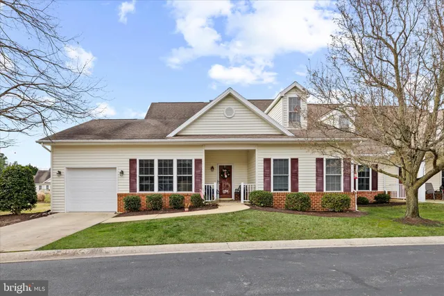a view of a dining room with furniture and a chandelier