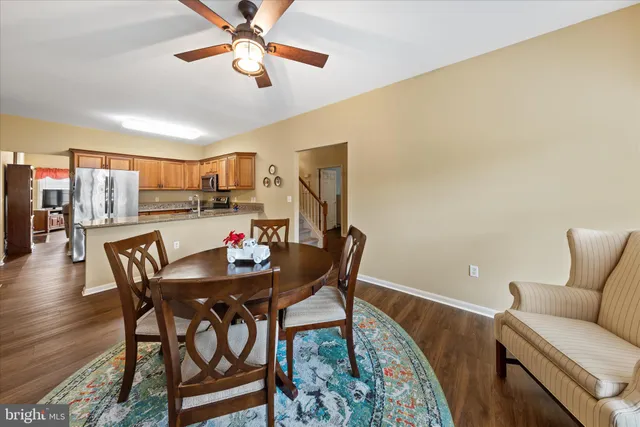 a kitchen with stainless steel appliances granite countertop a refrigerator a stove and a sink