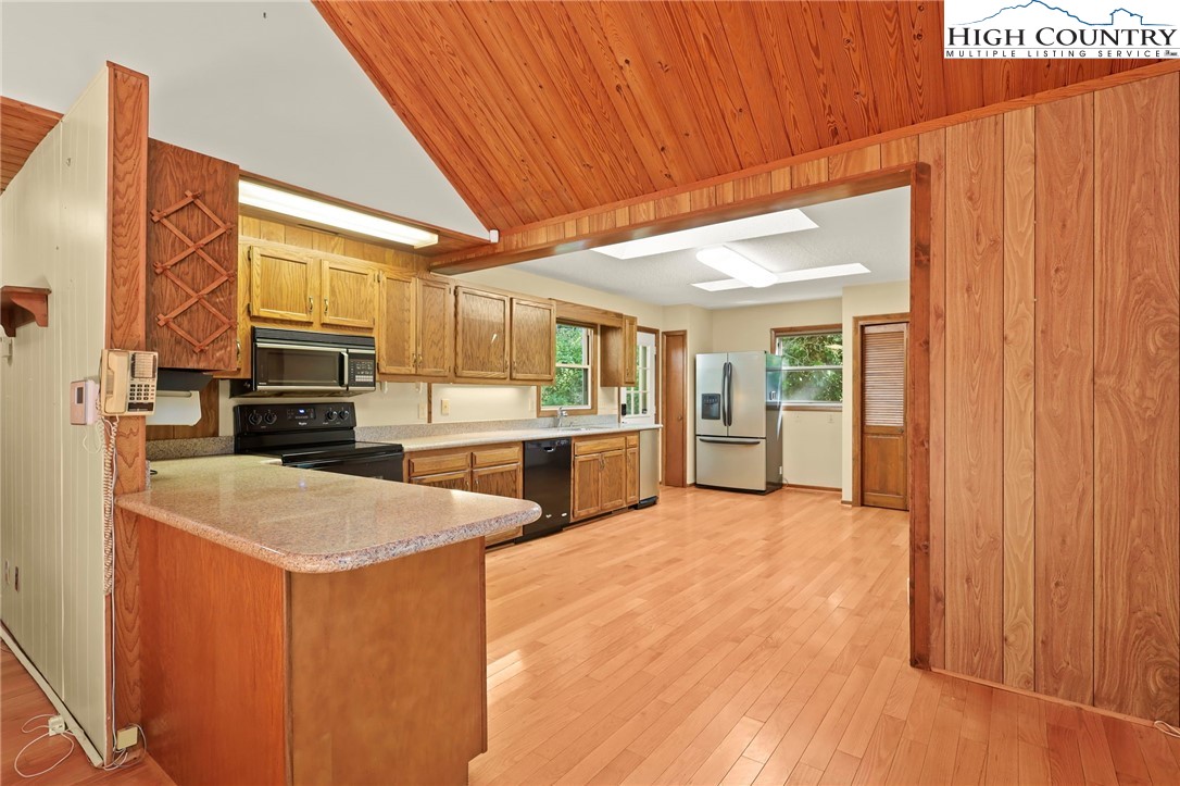 171 Jenny Lane Boone, NC 28607 - Photo 15 of 50 a view of kitchen with stainless steel appliances wooden floor and view living room