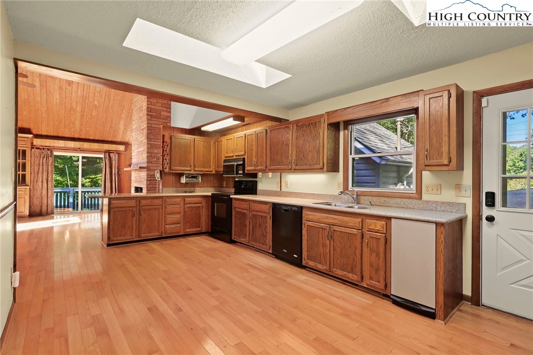 171 Jenny Lane Boone, NC 28607 - Photo 16 of 50 a kitchen with stainless steel appliances wooden floors and wooden cabinets