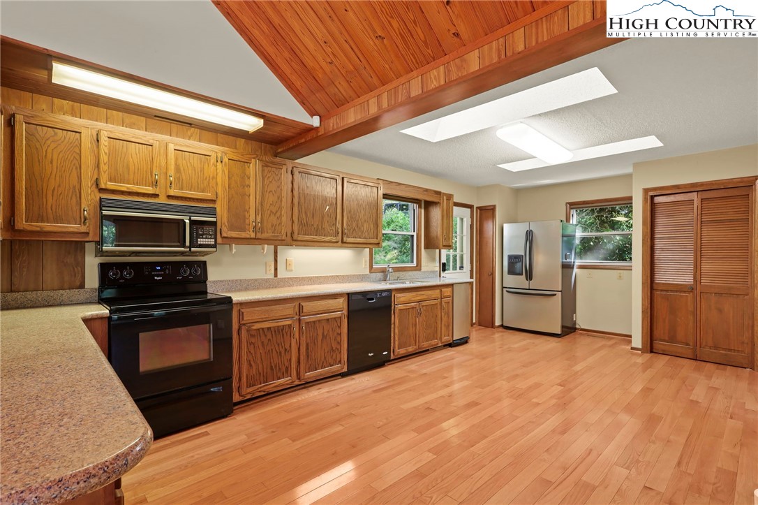 171 Jenny Lane Boone, NC 28607 - Photo 18 of 50 a kitchen with granite countertop stainless steel appliances and wooden cabinets
