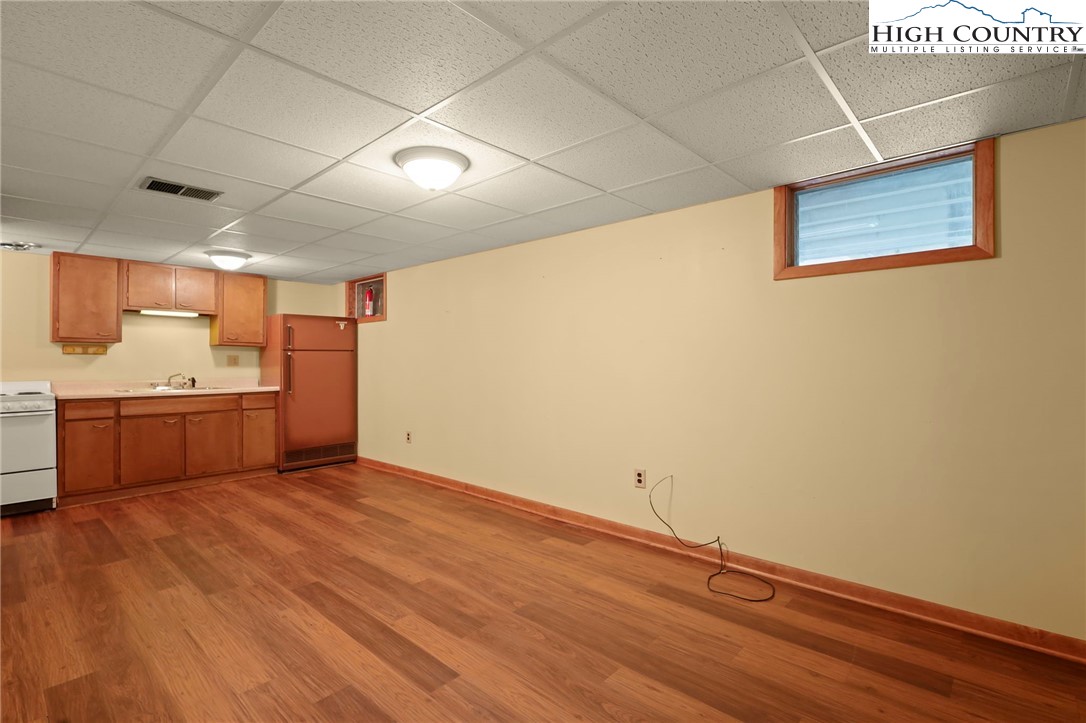 171 Jenny Lane Boone, NC 28607 - Photo 36 of 50 a view of a room with a wooden floor and a kitchen