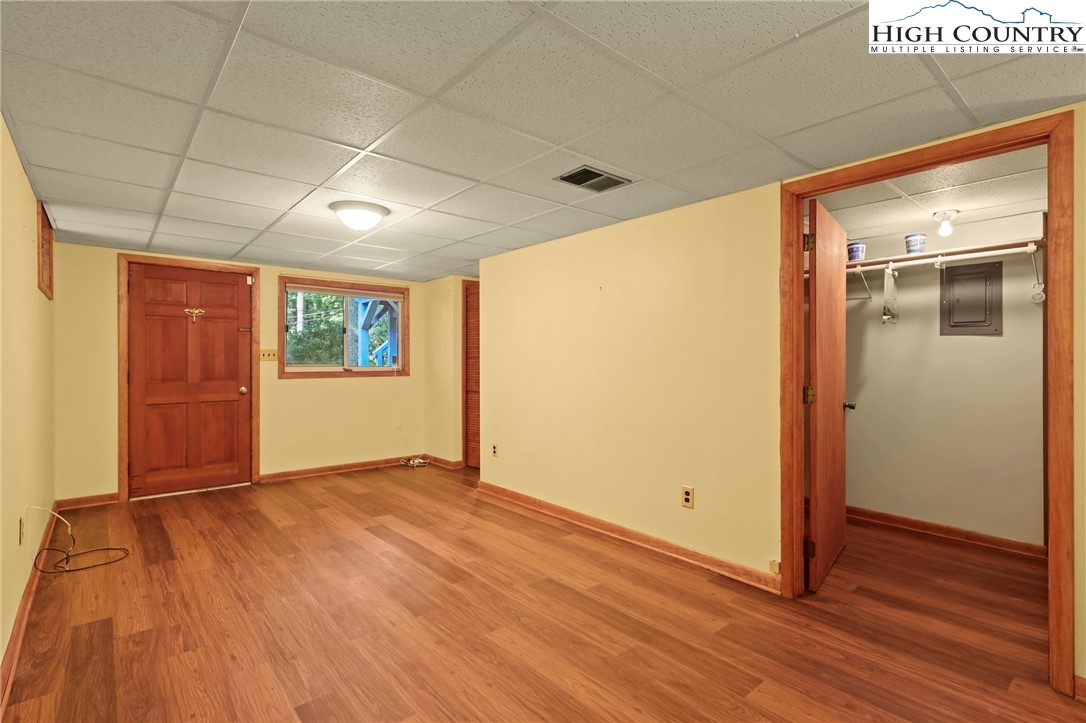 171 Jenny Lane Boone, NC 28607 - Photo 38 of 50 an empty room with wooden floor and windows