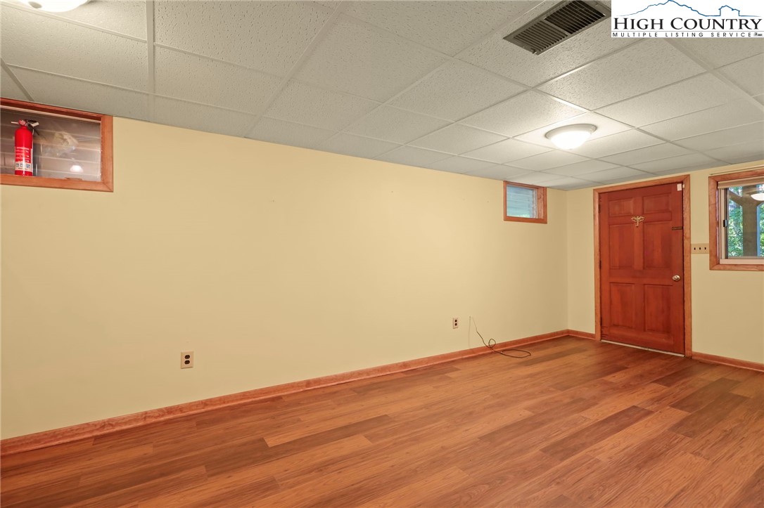 171 Jenny Lane Boone, NC 28607 - Photo 39 of 50 an empty room with wooden floor and windows