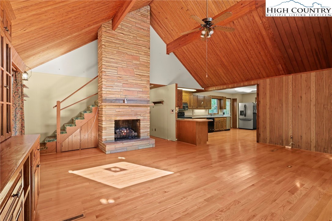171 Jenny Lane Boone, NC 28607 - Photo 8 of 50 a view of a livingroom with wooden floor and a fireplace