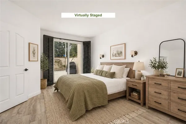 a bedroom with a bed and a large mirror