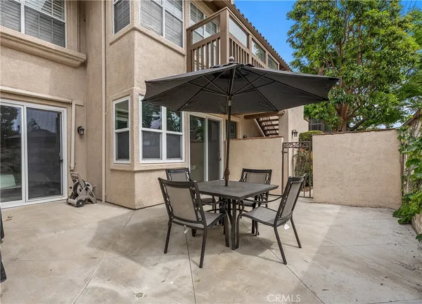 a table and chairs in patio of a house