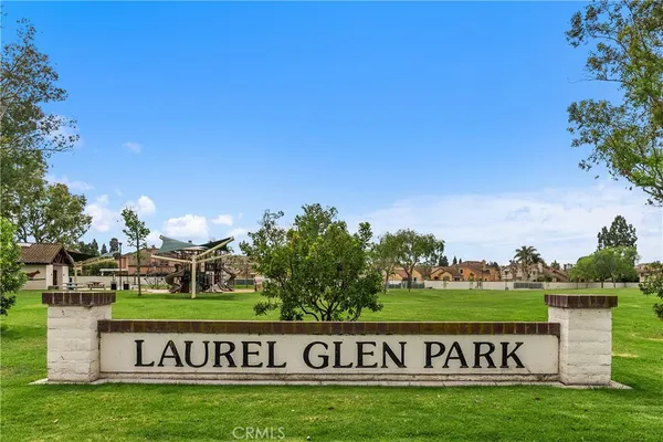 a view of a park and trees in the background