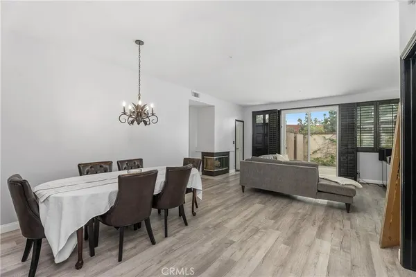 a view of a dining room with furniture wooden floor and chandelier