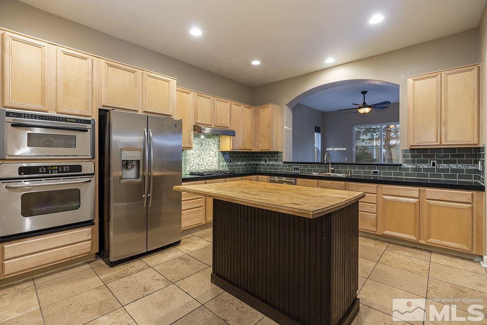 1672 Sawtooth Trail Reno, NV 89523 - Photo 11 of 25 a kitchen with kitchen island granite countertop a sink stove and refrigerator