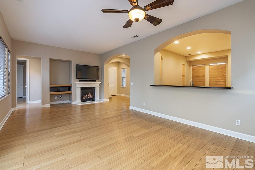 1672 Sawtooth Trail Reno, NV 89523 - Photo 7 of 25 a view of an empty room with wooden floor and a kitchen