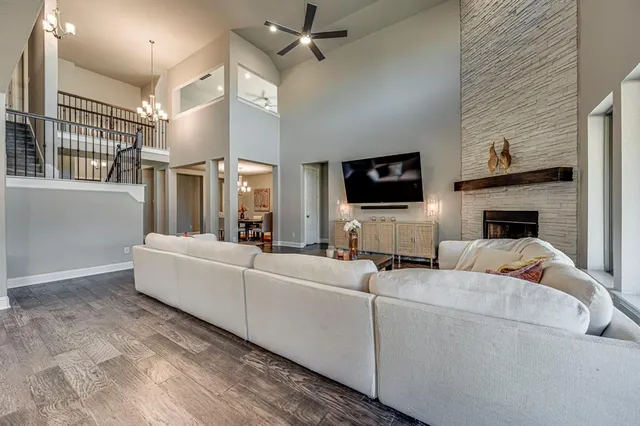 a living room with furniture a fireplace and a flat screen tv