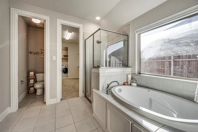 a bathroom with a granite countertop tub sink a mirror and a shower