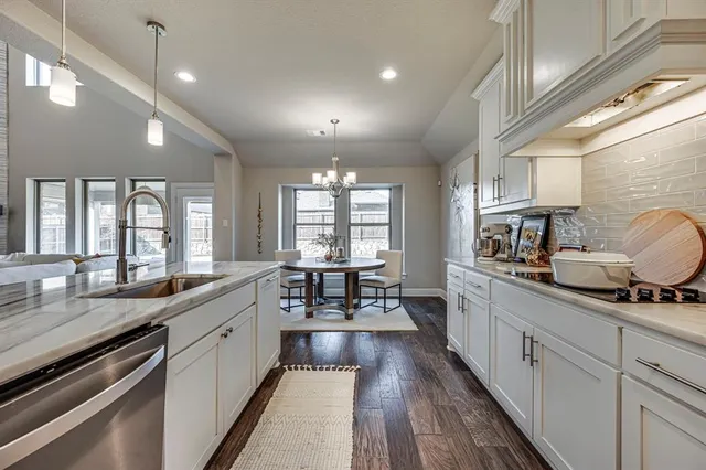 a large kitchen with kitchen island granite countertop a large window in it