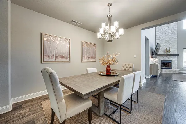 a view of a dining room with furniture wooden floor and chandelier