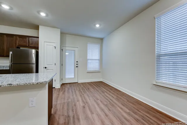 a view of a refrigerator in kitchen and wooden floor