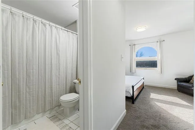 a bathroom with a toilet and a shower