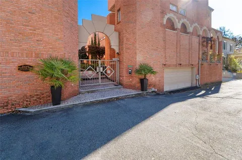 a view of a street with potted plants