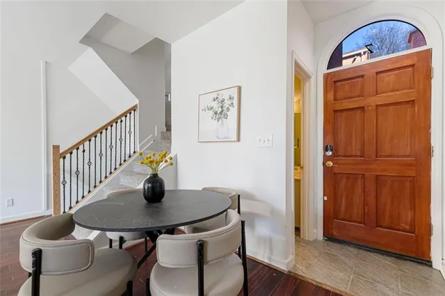 a dining room with furniture and wooden floor