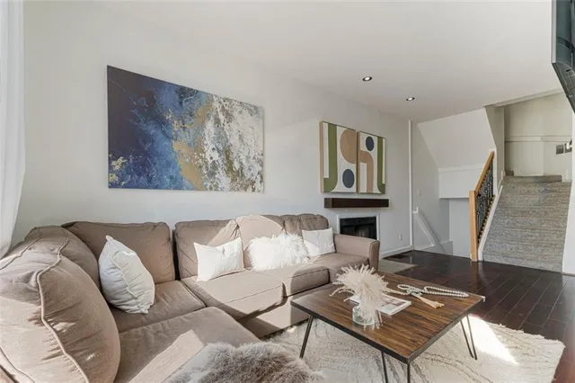 a living room with furniture a couch and wooden floor