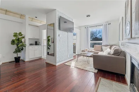 a living room with furniture and a potted plant