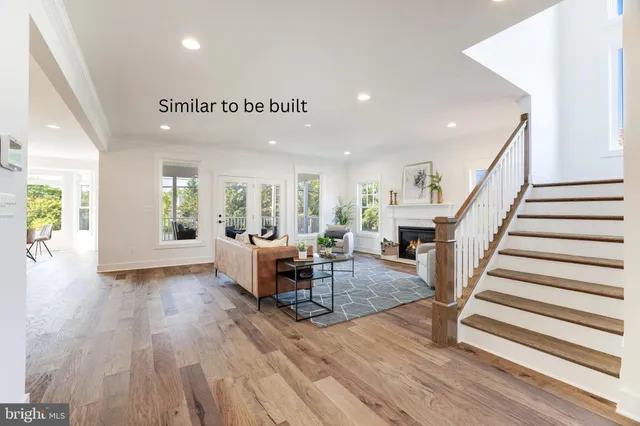 a view of entryway livingroom and hall with wooden floor
