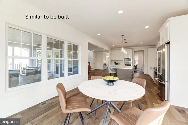 a view of a dining room with a table and chairs
