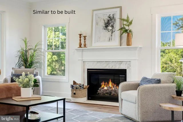 a living room with a fireplace and windows