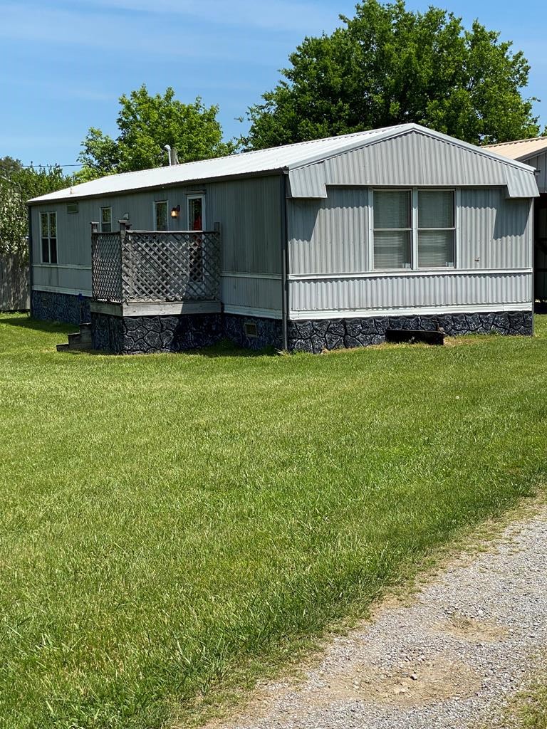 313 Lonesome Pine Road Bybee, TN 37713 - Photo 3 of 48 a back view of a house with a garden