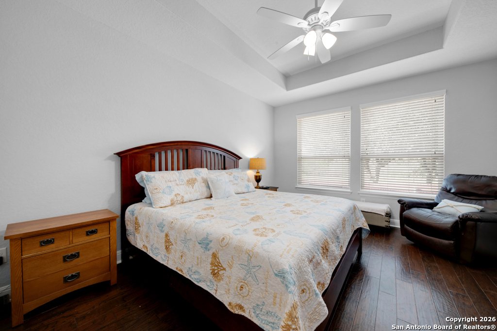 400 Bison Lane Cibolo, TX 78108 - Photo 17 of 34 a bedroom with a bed and a chandelier