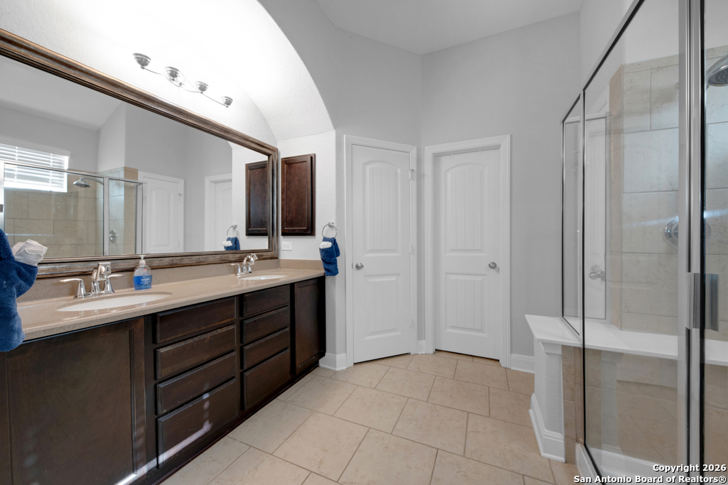 400 Bison Lane Cibolo, TX 78108 - Photo 19 of 34 a bathroom with a double vanity sink and mirror