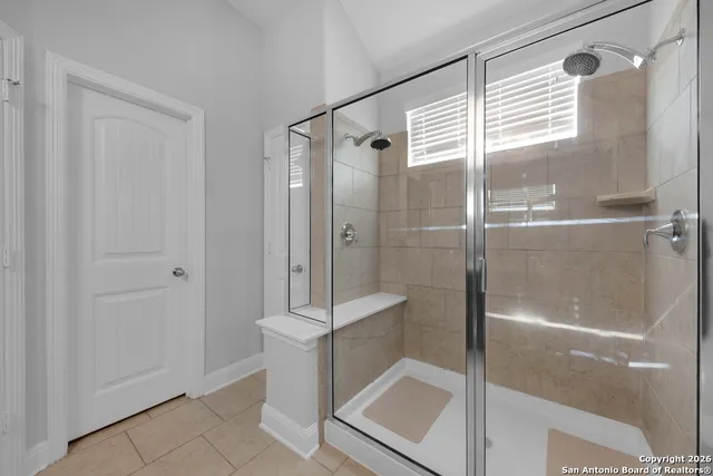 a bathroom with a glass shower door
