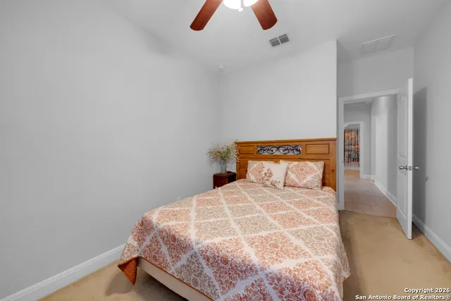 a bedroom with a bed and painting on the wall