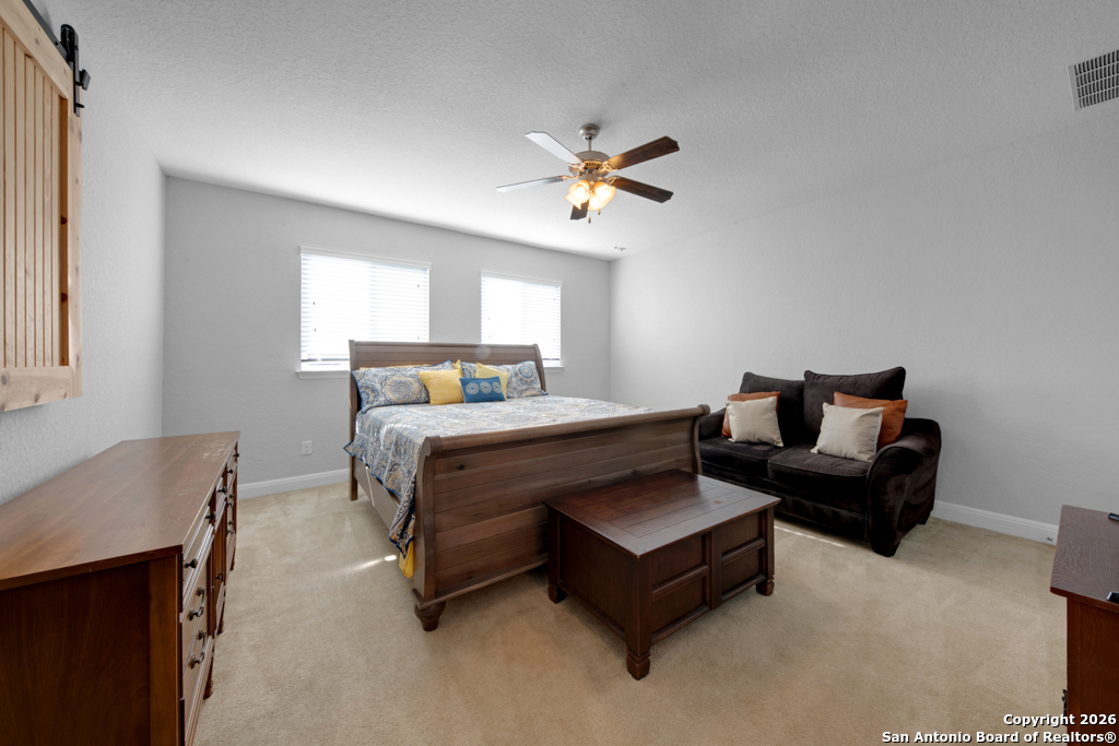 400 Bison Lane Cibolo, TX 78108 - Photo 28 of 34 a bedroom with a bed couch and a window