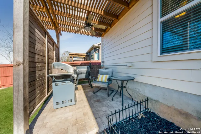 a view of a patio with table and chairs with wooden floor and fence
