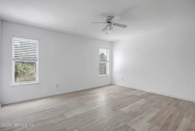 wooden floor in an empty room with a window
