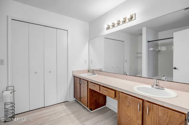 a bathroom with a double vanity sink and a mirror